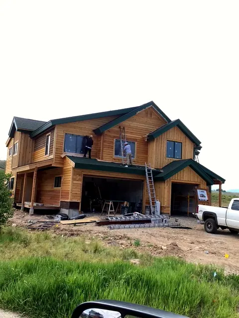 Rondeau Construction crew installing siding and windows on a new custom home