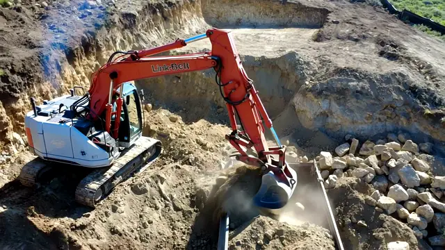 Excavator digging through rocky mountain ground for a foundation