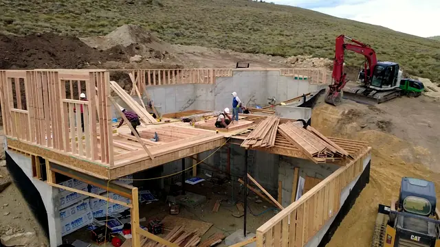 Rondeau Construction framing crew building first-floor walls with crane support