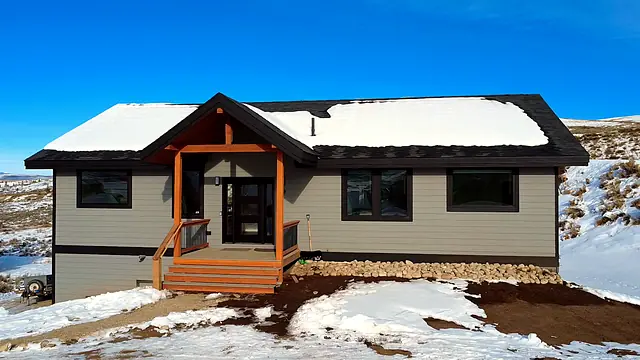 Finished single-story custom home with timber-frame porch built by Rondeau Construction