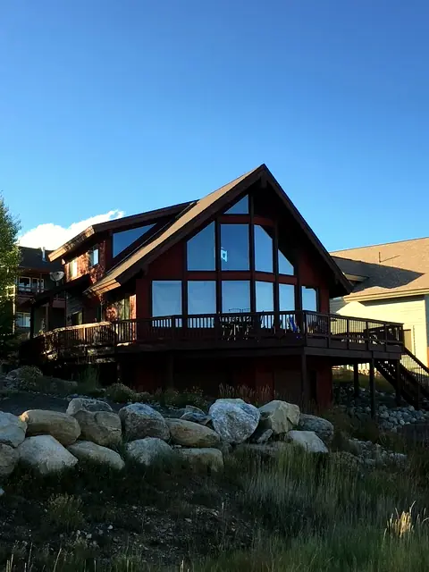 Custom home with a two-story glass great room and wraparound deck