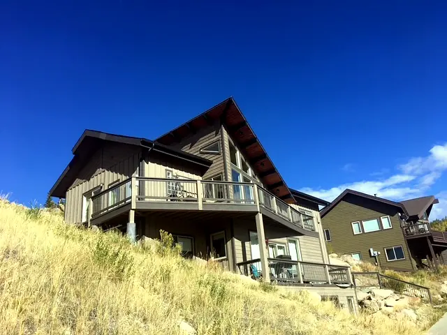 Custom hillside home with full-width rear decks overlooking the valley