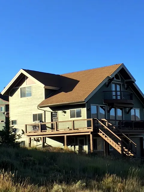 Modern cedar and gray custom home stepping down a Grand County hillside