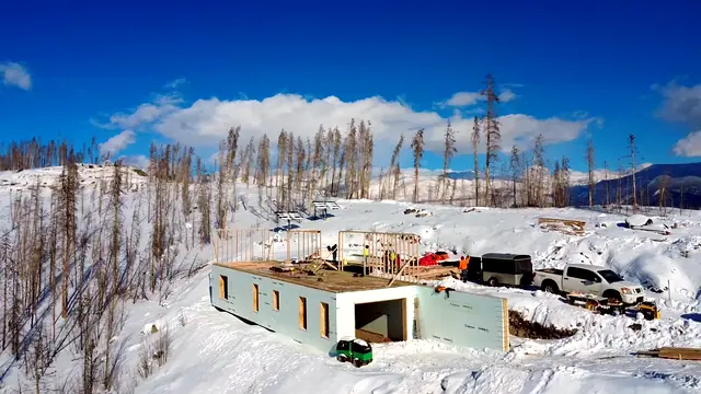 Winter construction site with foundation work underway in the snow
